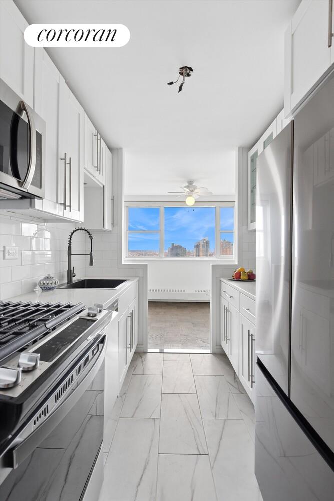 75 Henry Street, Unit 29H Brooklyn, NY 11201 - Photo 5 of 20 a kitchen with stainless steel appliances granite countertop a stove a sink and a refrigerator