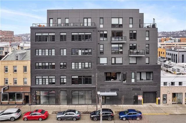 a front view of a building with parking space