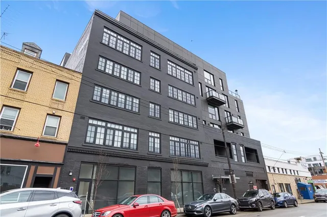 a front view of a building with parking space