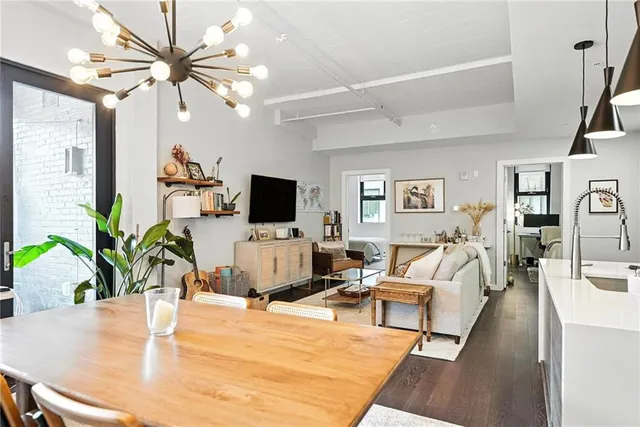 a living room with furniture a flat screen tv and a potted plant