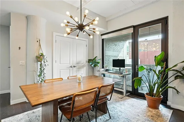 a dining room with furniture potted plants and a wooden floor