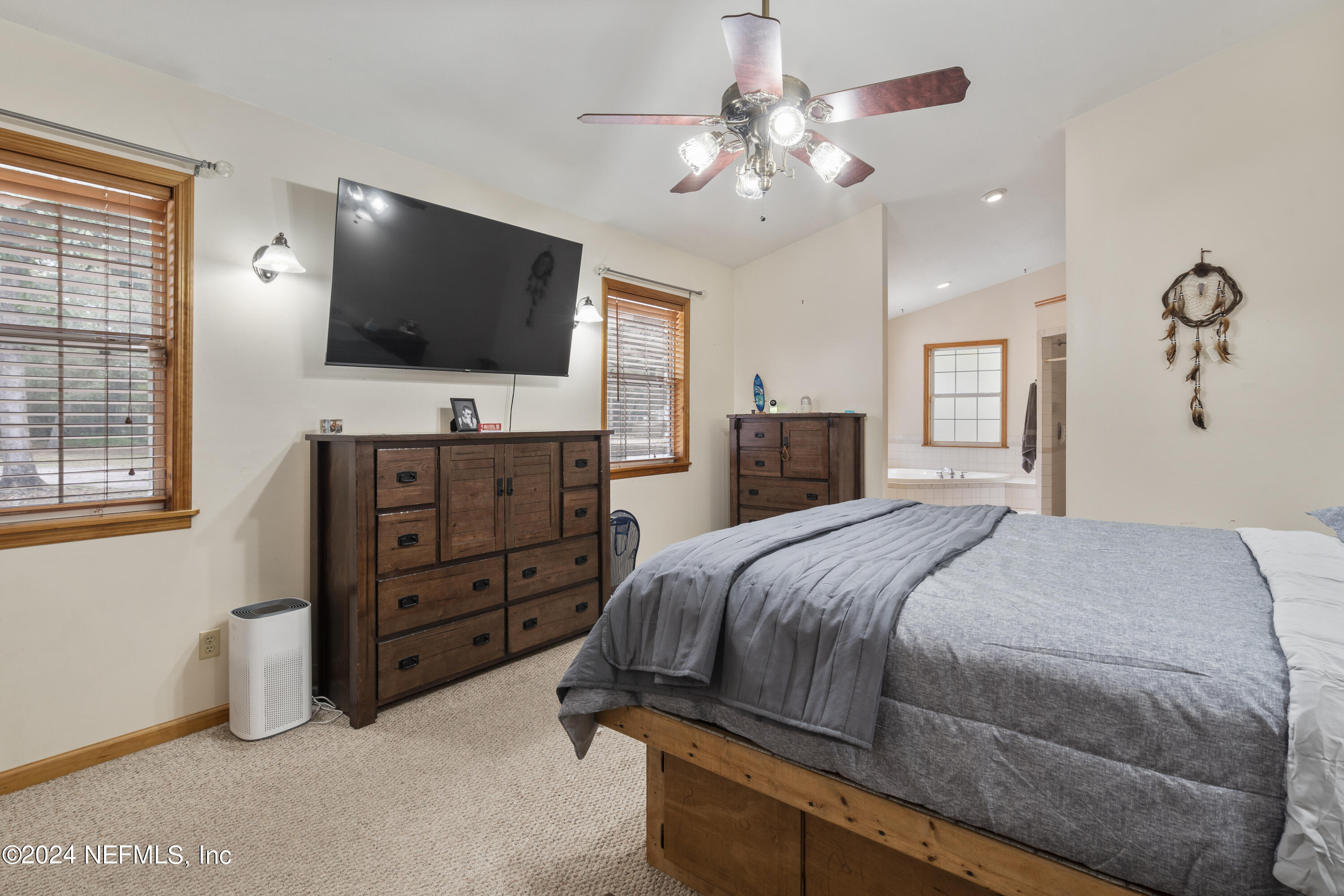 101 Tiffany Road Melrose, FL 32666 - Photo 9 of 51 a bedroom with a bed and a flat screen tv