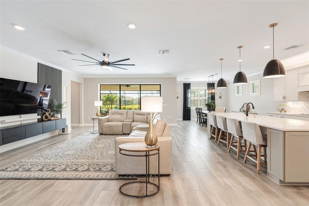 13303 Rinella Street Venice, FL 34293 - Photo 12 of 52 a living room with furniture and a flat screen tv