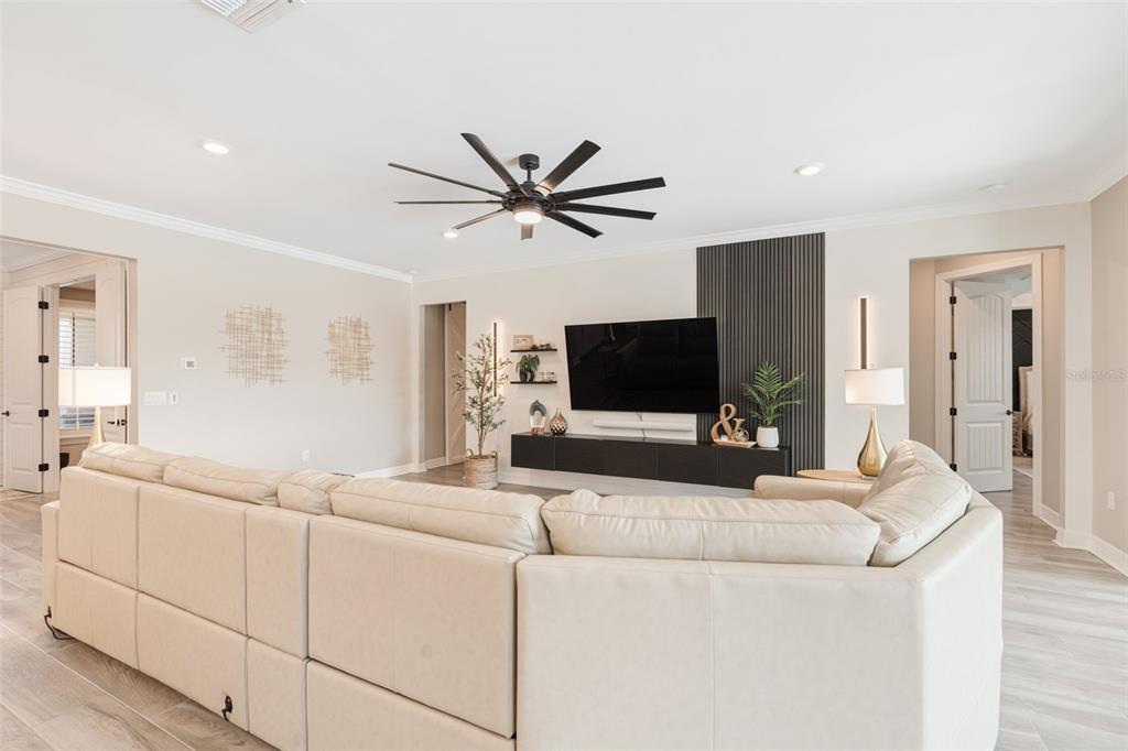 13303 Rinella Street Venice, FL 34293 - Photo 15 of 52 a living room with furniture and a flat screen tv