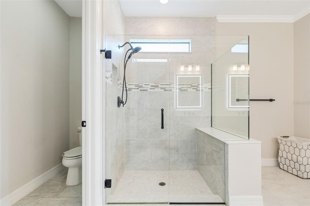 13303 Rinella Street Venice, FL 34293 - Photo 23 of 52 a bathroom with a glass shower door