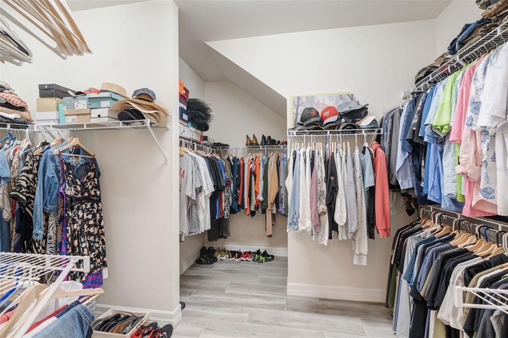 13303 Rinella Street Venice, FL 34293 - Photo 25 of 52 a view of walk in closet with clothes
