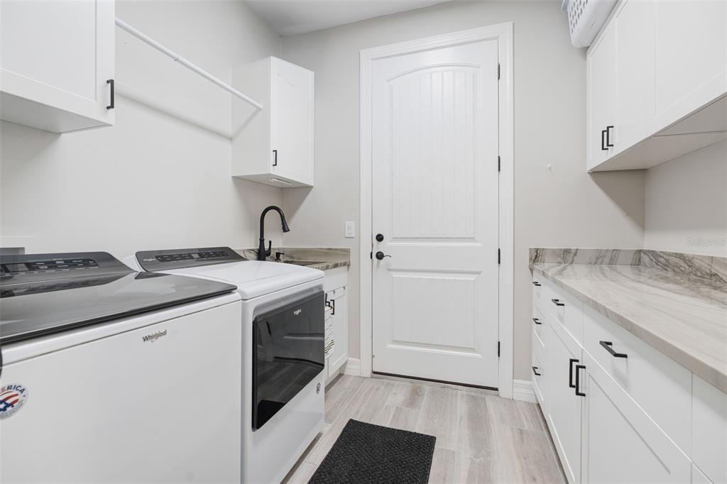 13303 Rinella Street Venice, FL 34293 - Photo 27 of 52 a kitchen with granite countertop cabinets stainless steel appliances and a sink