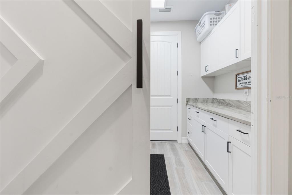 13303 Rinella Street Venice, FL 34293 - Photo 28 of 52 a kitchen with granite countertop white cabinets and white appliances