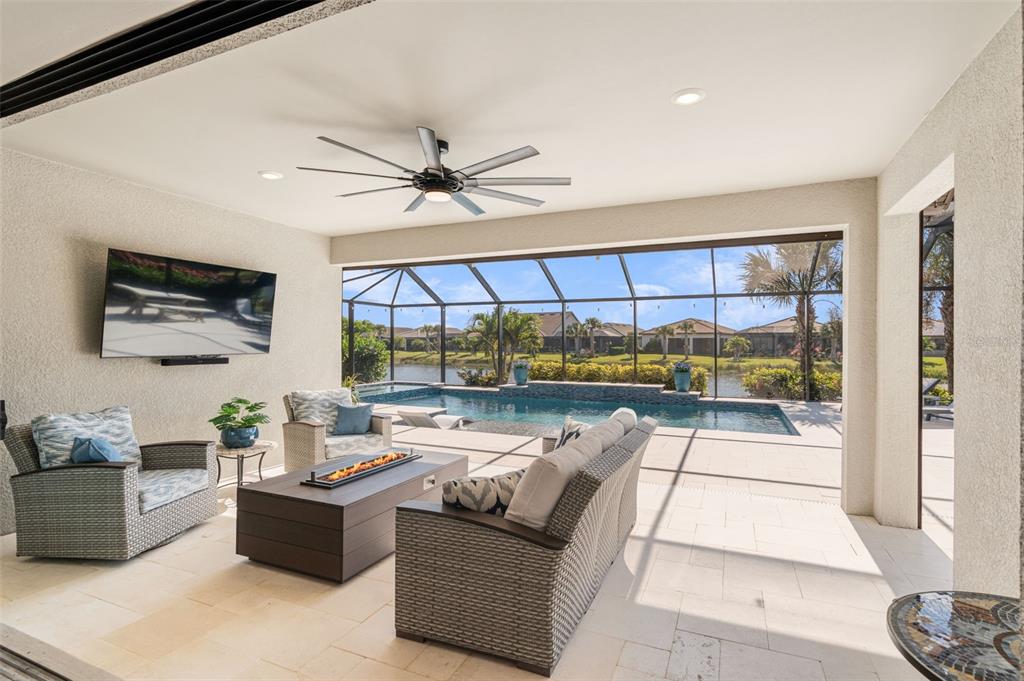 13303 Rinella Street Venice, FL 34293 - Photo 34 of 52 a living room with fireplace furniture and a large window