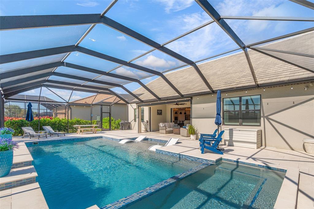 13303 Rinella Street Venice, FL 34293 - Photo 39 of 52 a view of a patio with table and chairs next to a yard