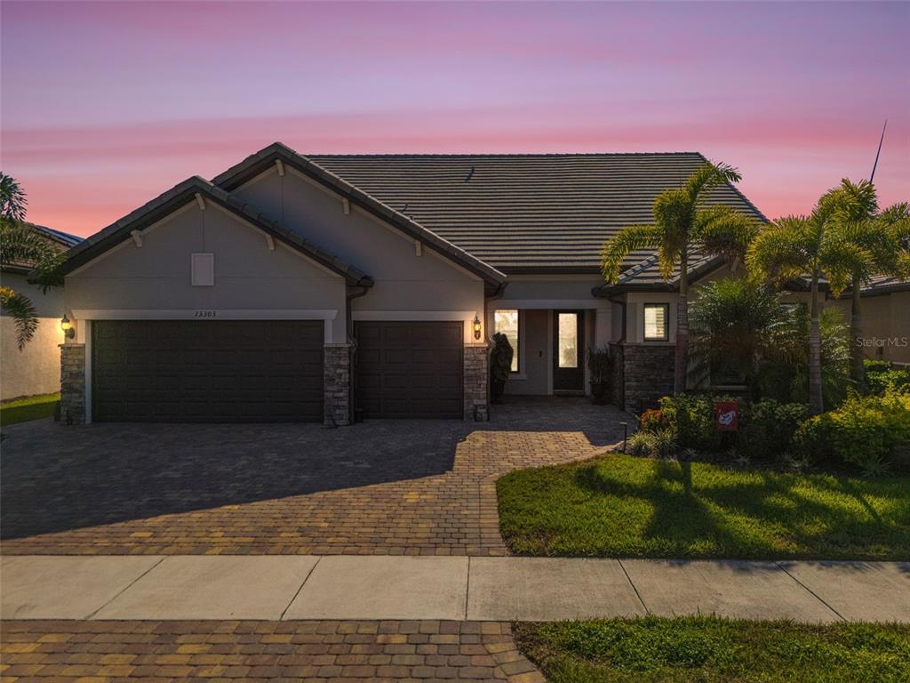 13303 Rinella Street Venice, FL 34293 - Photo 40 of 52 a front view of a house with a yard and garage