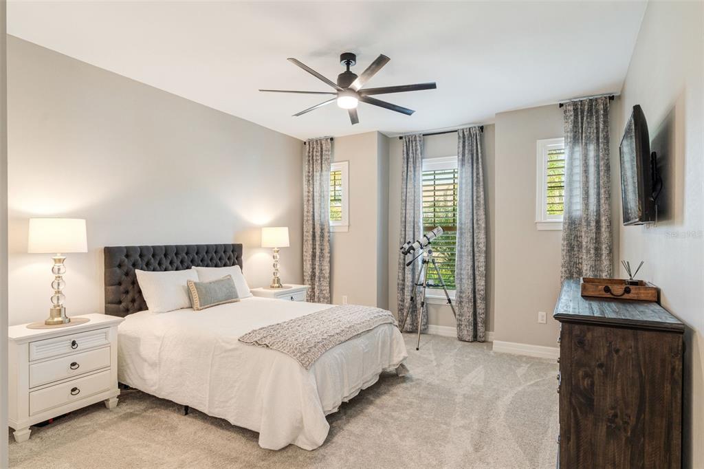 13303 Rinella Street Venice, FL 34293 - Photo 7 of 52 a bedroom with a bed and a chandelier