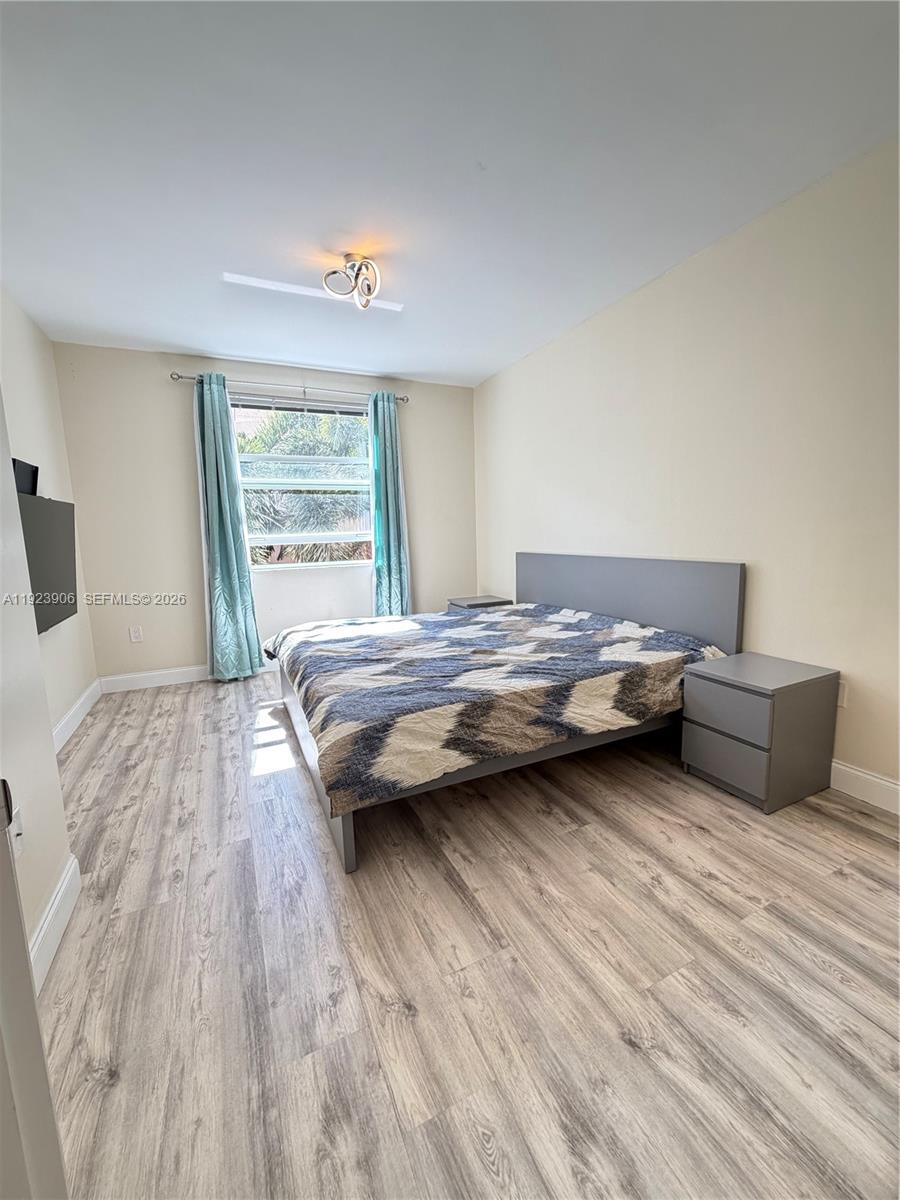 17150 North Bay Road, Unit 2419 Sunny Isles Beach, FL 33160 - Photo 11 of 27 a bedroom with a bed and a large window