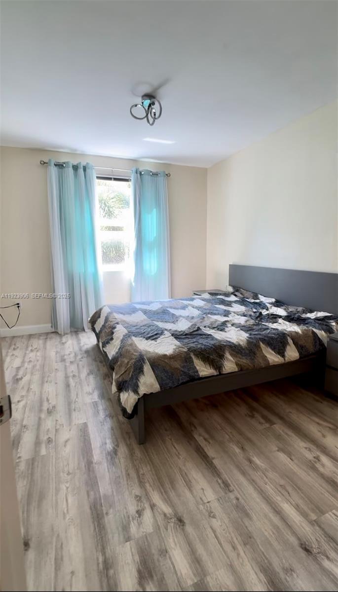 17150 North Bay Road, Unit 2419 Sunny Isles Beach, FL 33160 - Photo 11 of 12 a bedroom with a bed and a window