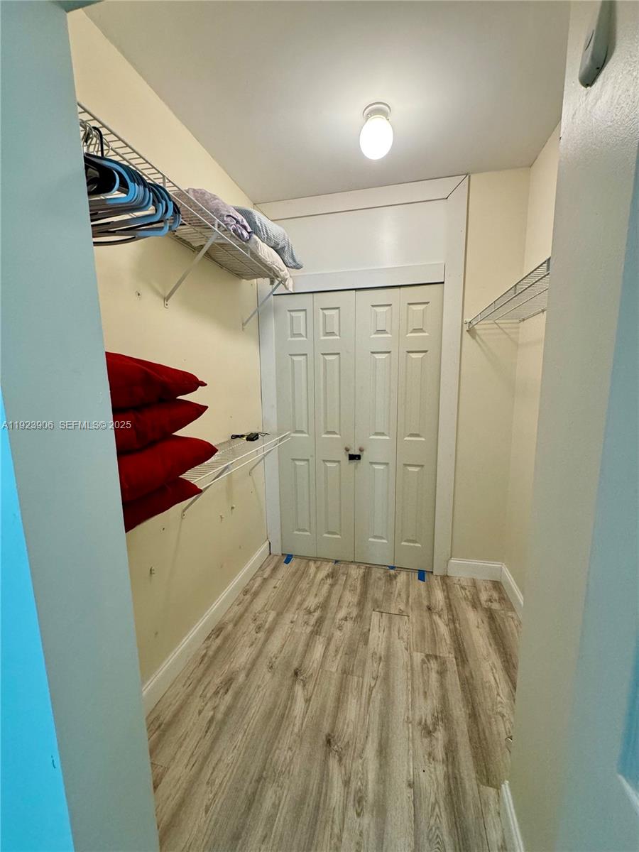 17150 North Bay Road, Unit 2419 Sunny Isles Beach, FL 33160 - Photo 12 of 12 a view of walk in closet with clothes and shoes