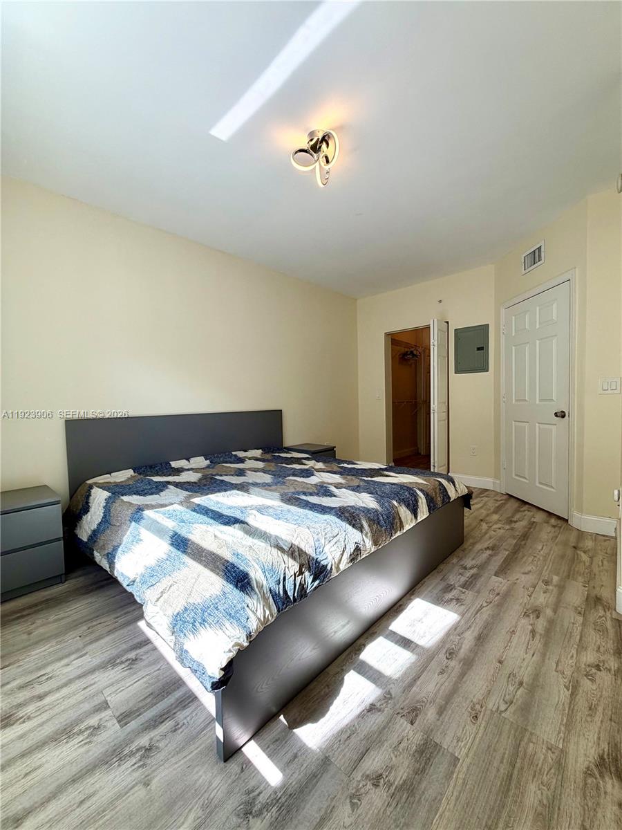 17150 North Bay Road, Unit 2419 Sunny Isles Beach, FL 33160 - Photo 13 of 27 a bedroom with a bed and a night stand