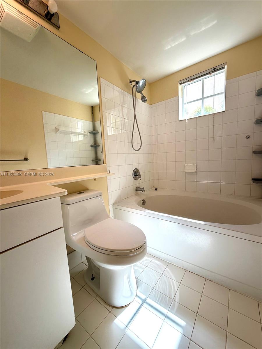 17150 North Bay Road, Unit 2419 Sunny Isles Beach, FL 33160 - Photo 15 of 27 a bathroom with a granite countertop toilet a sink and a bathtub