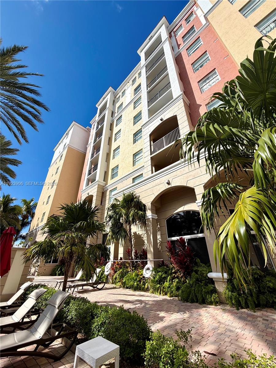 17150 North Bay Road, Unit 2419 Sunny Isles Beach, FL 33160 - Photo 16 of 27 a front view of a multi story residential apartment building with yard