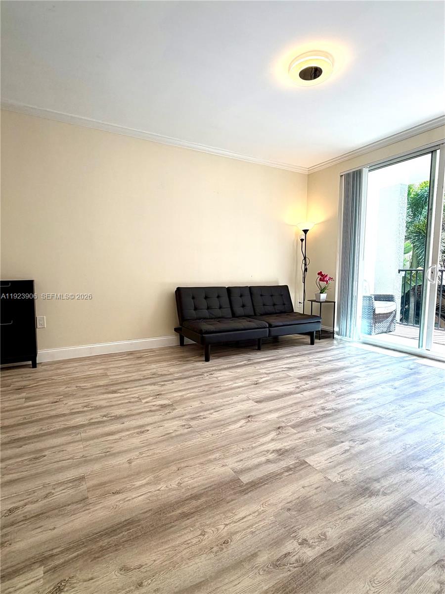 17150 North Bay Road, Unit 2419 Sunny Isles Beach, FL 33160 - Photo 3 of 27 a view of a bedroom with wooden floor and windows