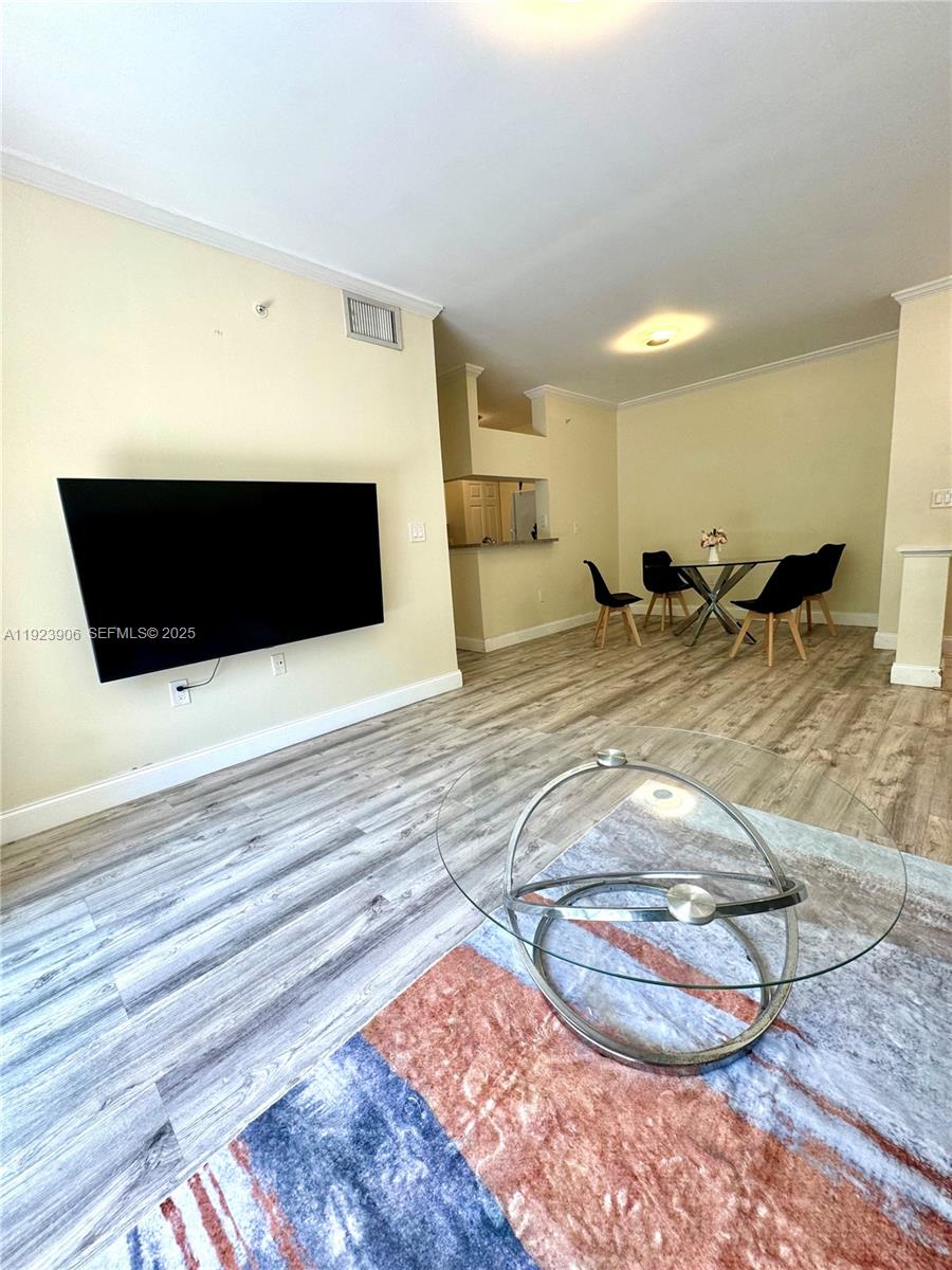 17150 North Bay Road, Unit 2419 Sunny Isles Beach, FL 33160 - Photo 3 of 12 a view of a living room and a fireplace