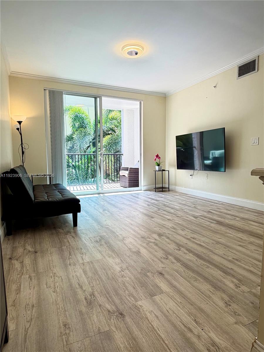 17150 North Bay Road, Unit 2419 Sunny Isles Beach, FL 33160 - Photo 4 of 27 a living room with furniture and a flat screen tv