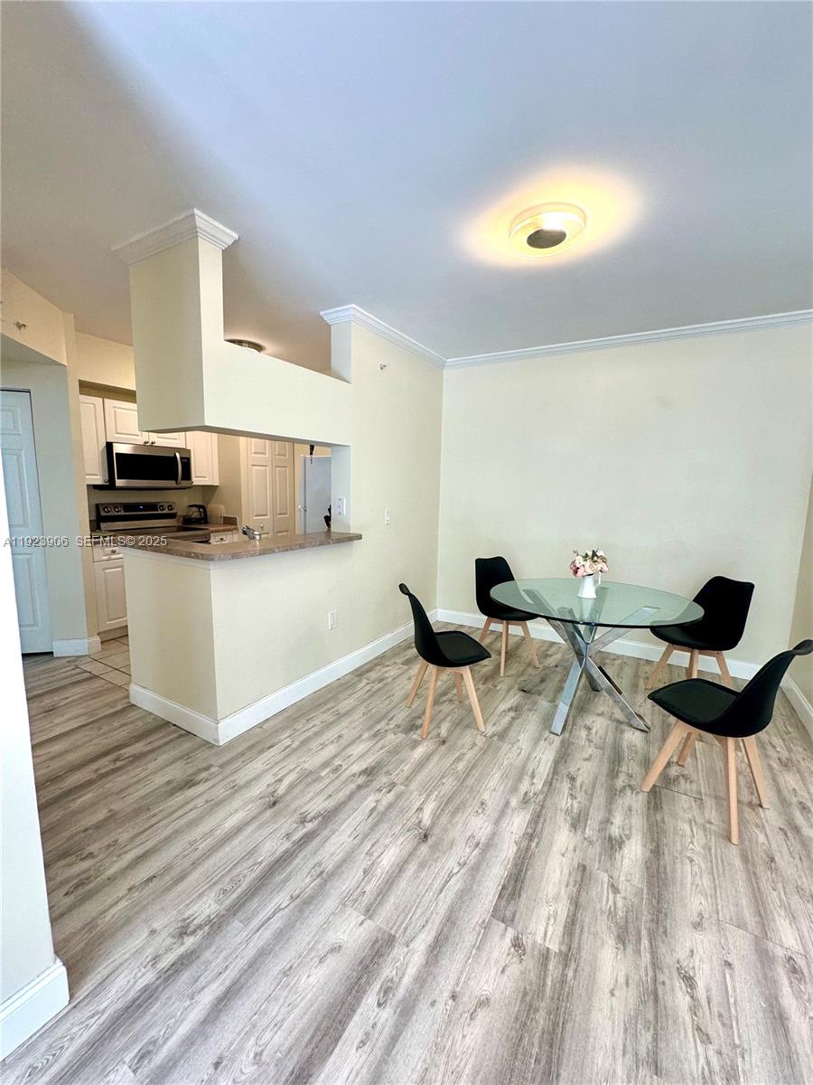 17150 North Bay Road, Unit 2419 Sunny Isles Beach, FL 33160 - Photo 4 of 12 a living room with furniture and a wooden floor