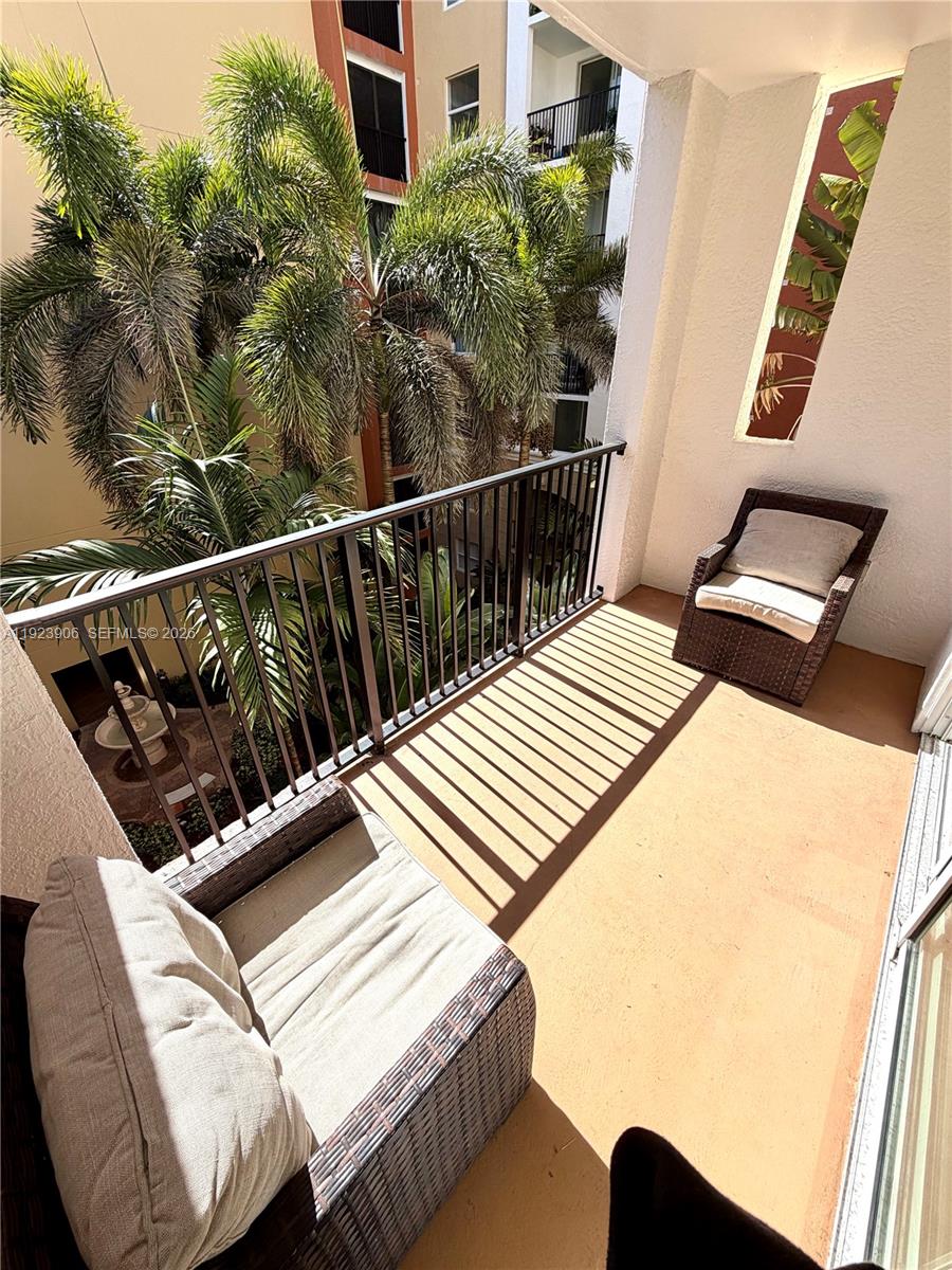 17150 North Bay Road, Unit 2419 Sunny Isles Beach, FL 33160 - Photo 6 of 27 a balcony with table and chairs