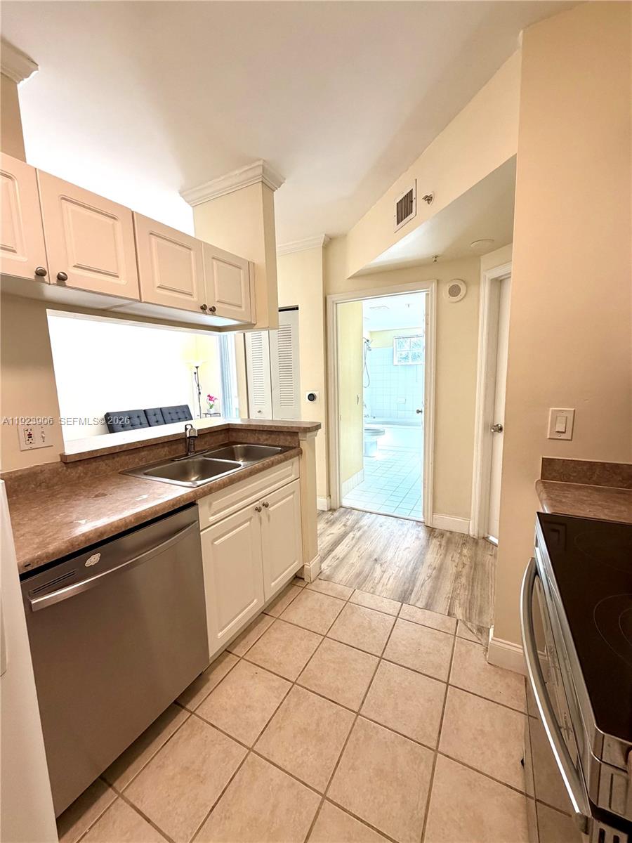 17150 North Bay Road, Unit 2419 Sunny Isles Beach, FL 33160 - Photo 9 of 27 a kitchen with a stove a sink and a refrigerator