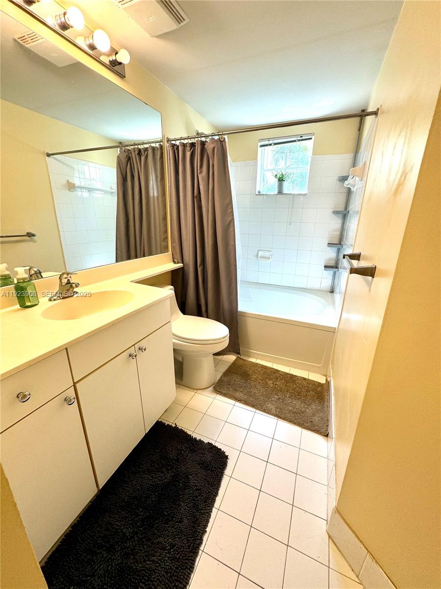 17150 North Bay Road, Unit 2419 Sunny Isles Beach, FL 33160 - Photo 10 of 12 a bathroom with a sink a toilet and shower