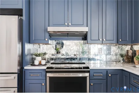 a kitchen with a stove and cabinets