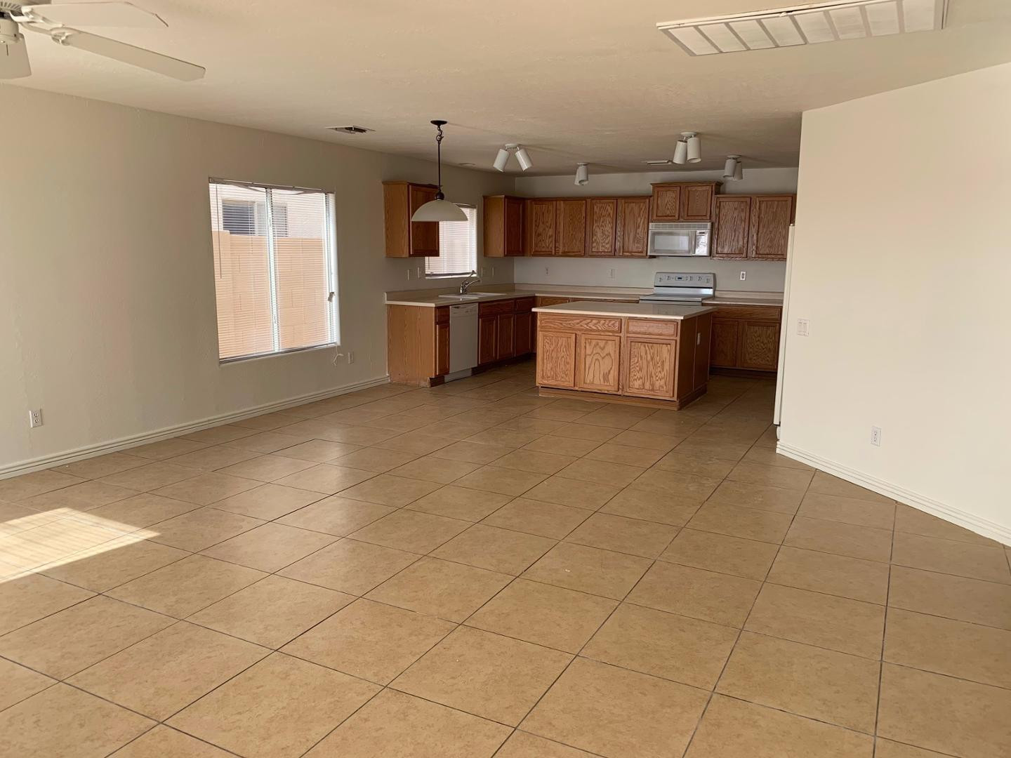 43589 West Cowpath Road Maricopa, AZ 85138 - Photo 3 of 6 a kitchen with kitchen island granite countertop a sink cabinets and stainless steel appliances