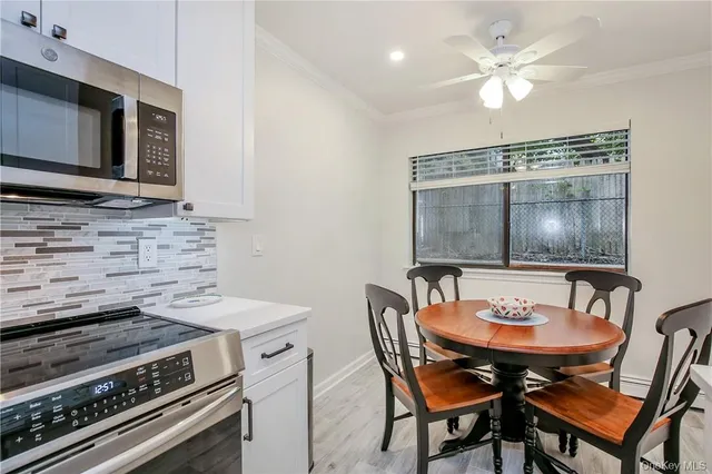 a kitchen with granite countertop a sink stove and refrigerator