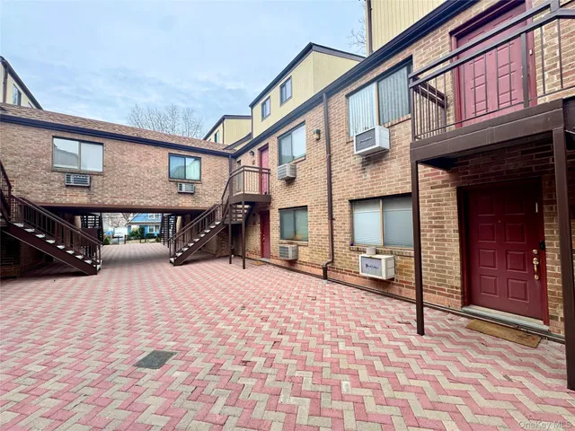 a brick building with a door and a shower