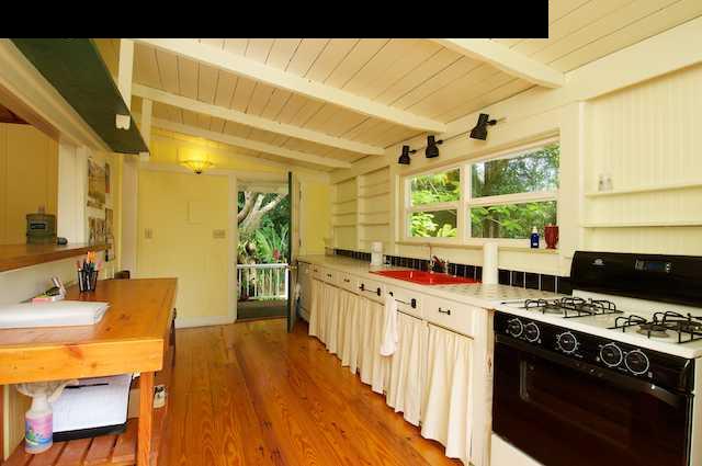 490 Kaupakalua Road Haiku, HI 96708 - Photo 12 of 30 a kitchen with stainless steel appliances granite countertop a stove and a refrigerator