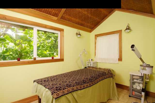 490 Kaupakalua Road Haiku, HI 96708 - Photo 24 of 30 a bedroom with a bed and a table in it