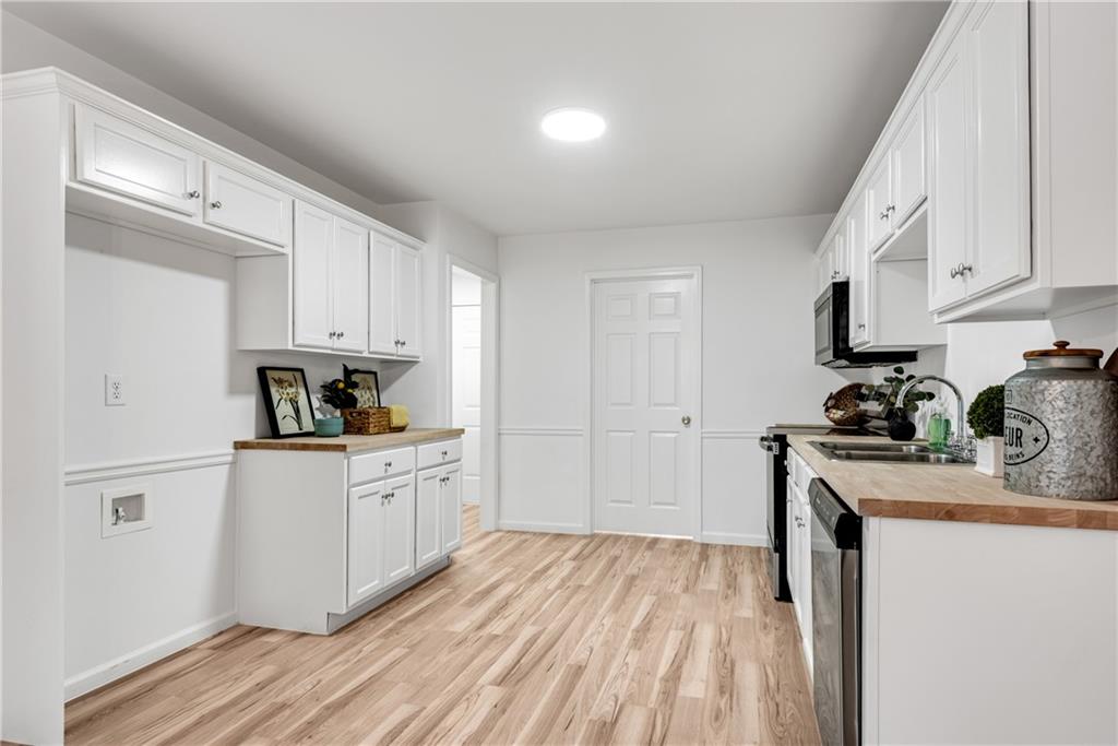 125 Pine Ridge Trace Athens, GA 30605 - Photo 9 of 28 a kitchen with white cabinets sink and stainless steel appliances