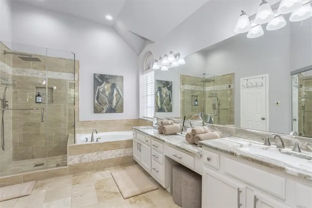 a spacious bathroom with a double vanity sink a large mirror and shower
