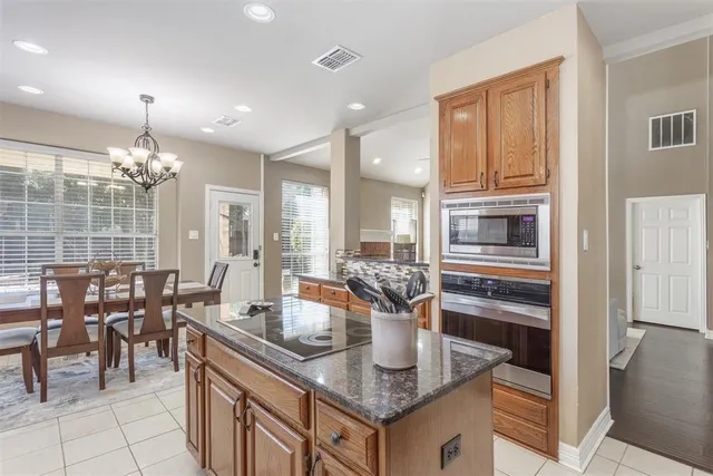 a kitchen with granite countertop a sink and cabinets