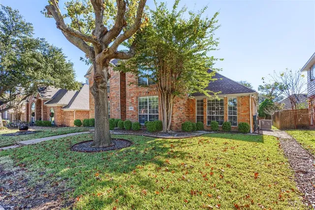 a view of a house with a tree in a yard
