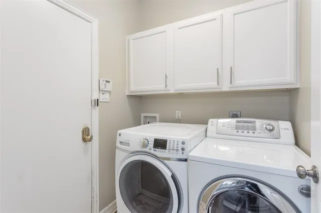 a view of washer and dryer with kitchen in the background