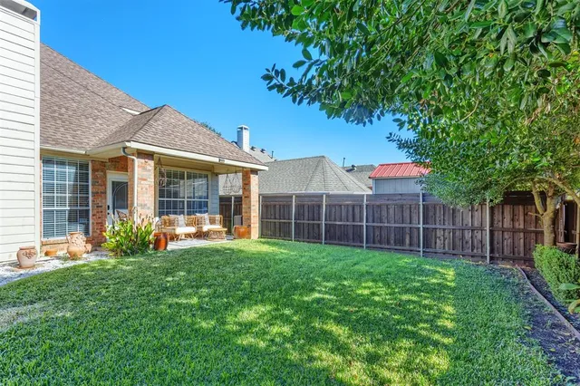 a view of a house with a yard and porch