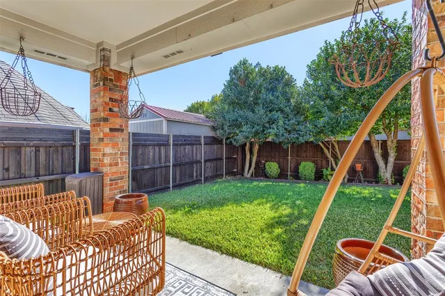 a view of backyard with deck and a slide