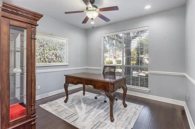a view of a workspace with furniture and a window