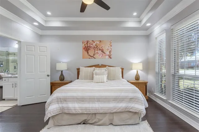 a bedroom with a large bed and a chandelier