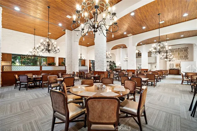 a very nice looking living room with chairs and kitchen view