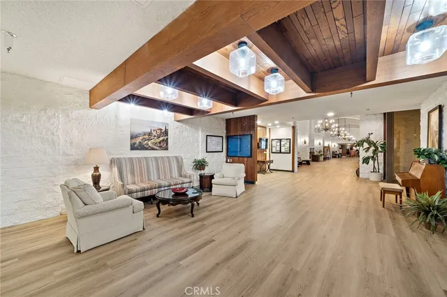 a living room with furniture a chandelier and a dining table