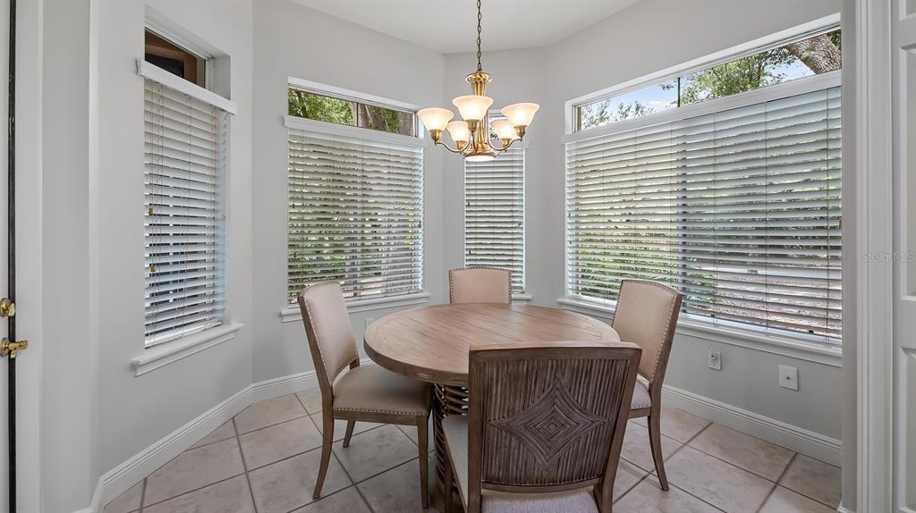 102 Camino Real, Unit 102 Howey-in-the-Hills, FL 34737 - Photo 16 of 62 a view of a dining room with furniture and window