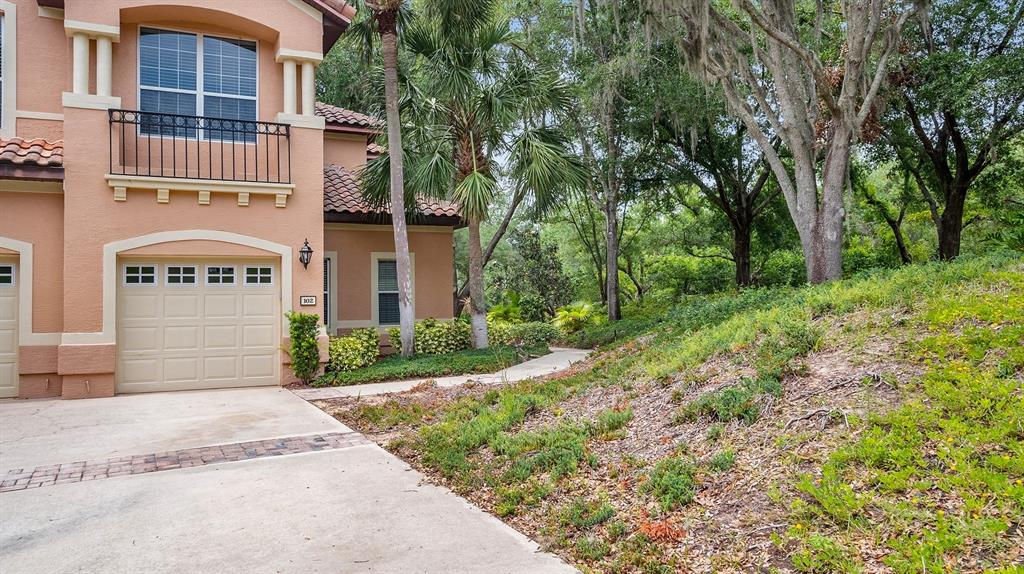 102 Camino Real, Unit 102 Howey-in-the-Hills, FL 34737 - Photo 28 of 62 a pathway of a house with a yard and large trees