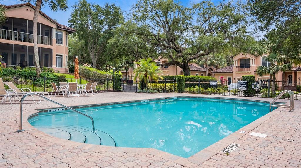 102 Camino Real, Unit 102 Howey-in-the-Hills, FL 34737 - Photo 31 of 62 a swimming pool with outdoor seating and yard