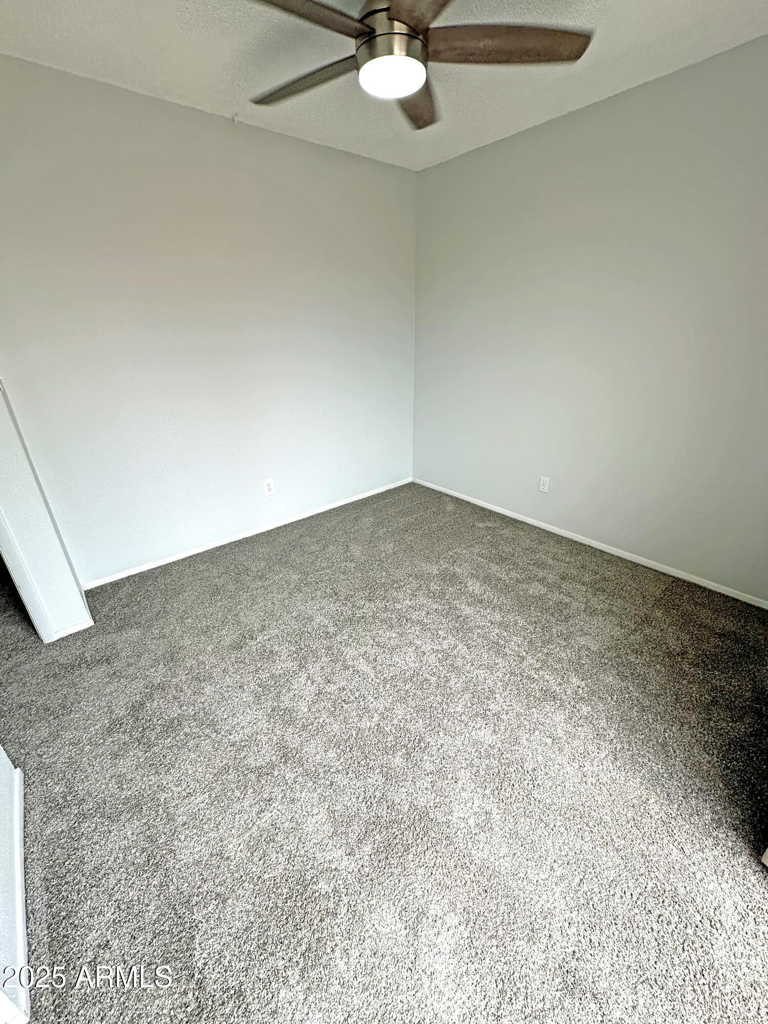 6018 North 79th Street Scottsdale, AZ 85250 - Photo 14 of 24 an empty room with a ceiling fan and carpet